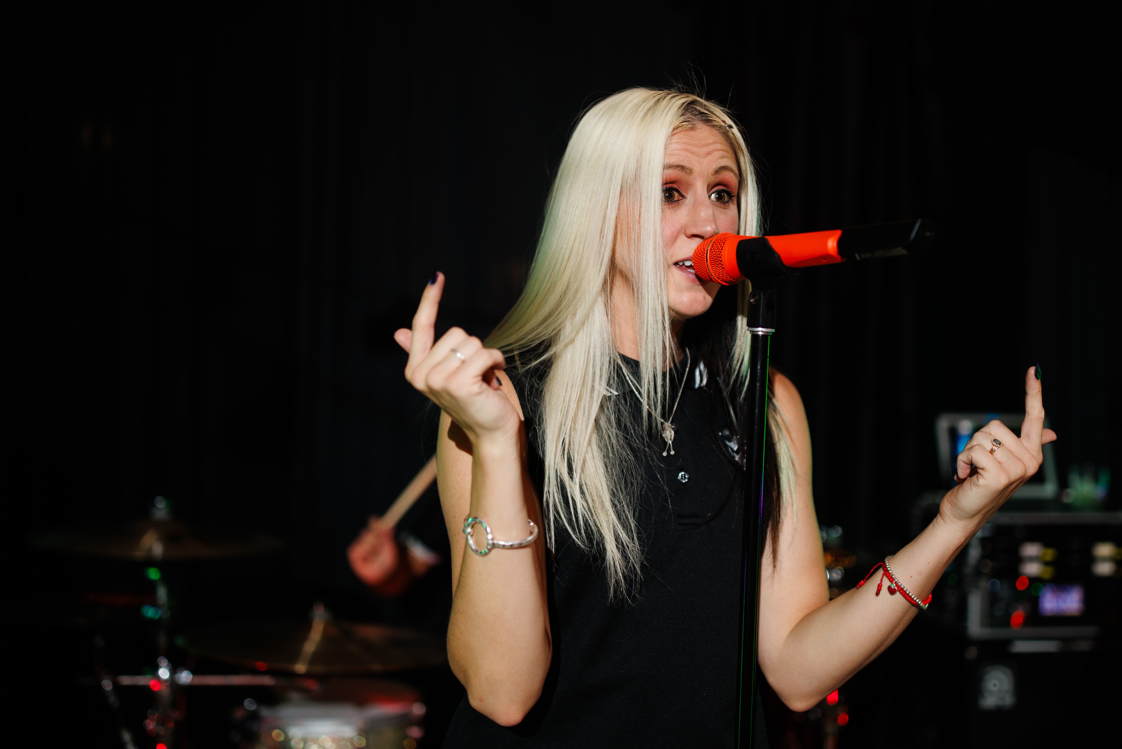 Lead vocalist performing with red microphone