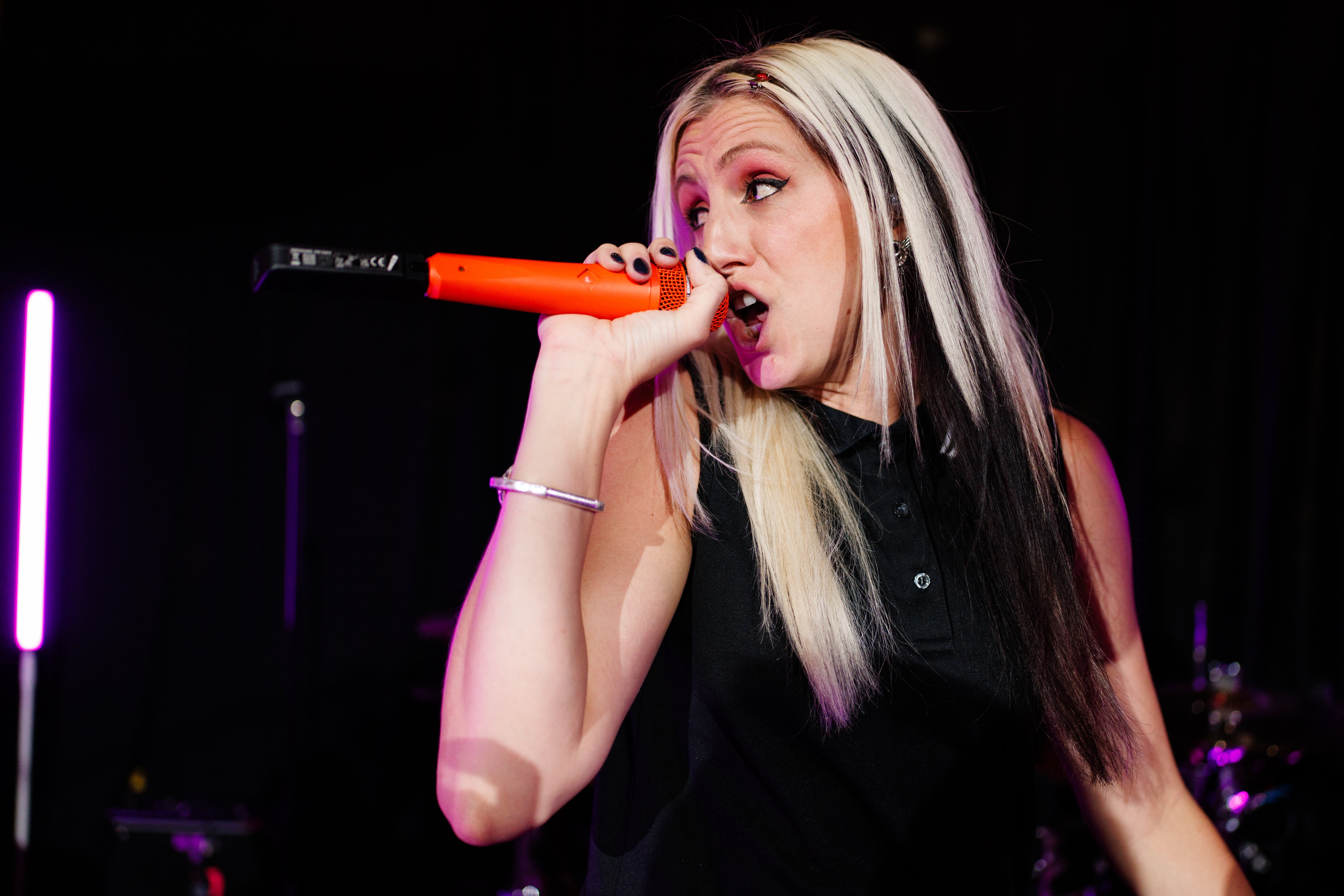 Female singer performing with red microphone